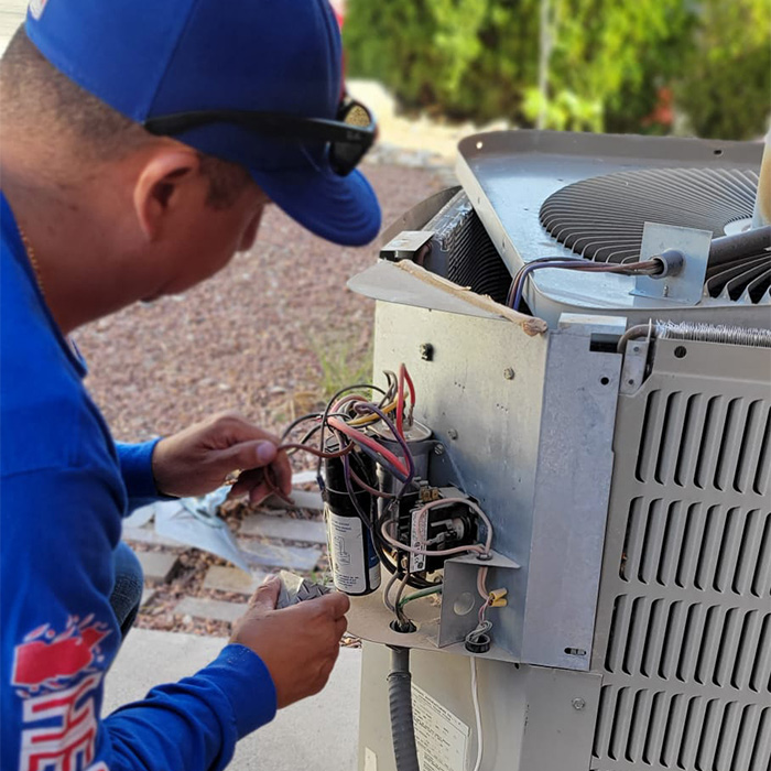 technician-close-up-repairing-air-conditioner-at-house-exteriors-el-paso-tx